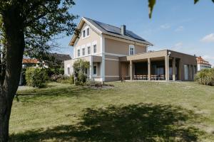 a house with a large yard in front of it at Das Sonnengleis in Lutzmannsburg