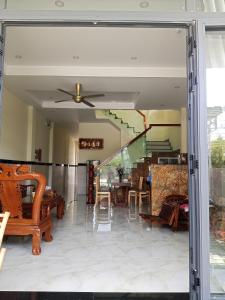 a living room with a table and chairs at Homestay Kim Thuy in Hiếu Xương