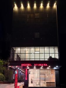 a building with a hotel viviana at night at Hotel Vivanta in Bānswāra