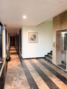 a hallway of a building with a tile floor at Hotel Vivanta in Bānswāra