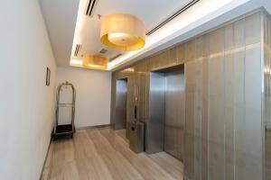a hallway with a elevator and a walk in door at Kingston Hotel 22 - Cheras, Kuala Lumpur in Kuala Lumpur