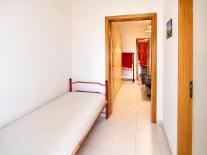 a bedroom with a bed and a hallway at Cala Rossa 35 Wit Pool - Elba Affitti in Nisporto +3 photos