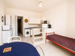 a small kitchen with a table and a couch in a room at Cala Rossa 35 Wit Pool - Elba Affitti in Nisporto