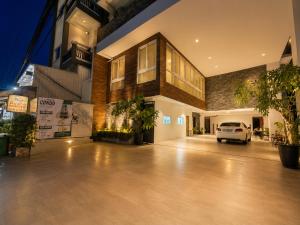 a building with a white van parked in a parking lot at Sopor Resident in Phnom Penh +44 photos