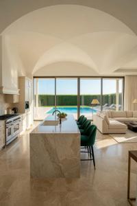 a kitchen and living room with a large marble table at Home Mykonos lux in Casoria