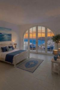 a bedroom with a bed with a view of the ocean at Home Mykonos lux in Casoria