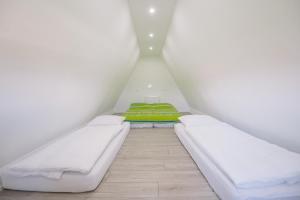 a small room with two beds in a attic at Vila Paola in Kupres