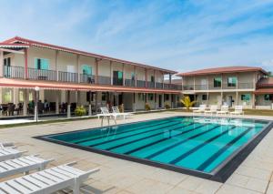 a swimming pool in front of a hotel at Nilakma Lagoon in Negombo