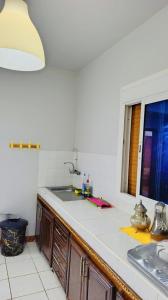 a kitchen counter with a sink and a window at Comfort Apartment in Einzorene +1 photo