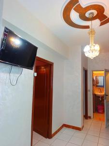 a flat screen tv hanging on the ceiling of a room at Comfort Apartment in Einzorene