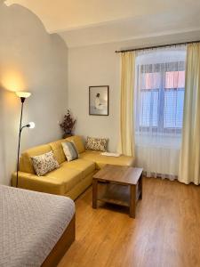 a living room with a couch and a table at APARTAMENT PLAC KATEDRALNY in Tarnów