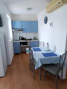 a kitchen and dining room with a table and chairs at Apartments Blue House in Korčula +25 photos