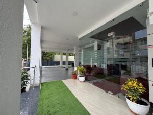 an external view of a building with potted plants at Hotel V Stay in Chennai