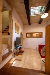 a living room with a red couch and a television at 3Cities Maison close to Valletta in Cospicua +73 photos