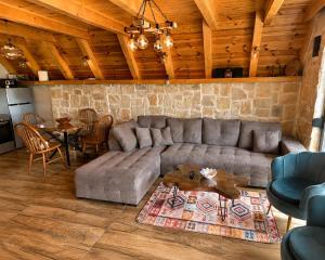 a living room with a couch and a table at Mountain Whisper in Žabljak +15 photos