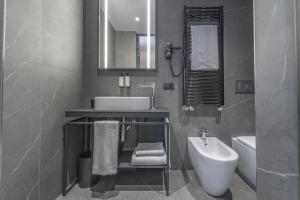 a bathroom with a sink and a toilet and a mirror at Palazzo Vittoria Hotel Milano in Milan +16 photos