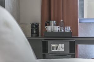 a hotel room with a coffee maker on a counter at Palazzo Vittoria Hotel Milano in Milan