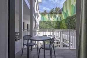 a balcony with two chairs and a table on a balcony at Palazzo Vittoria Hotel Milano in Milan