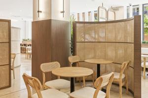 a restaurant with two tables and chairs in a room at B&B HOTEL Zaragoza Los Enlaces Estación in Zaragoza