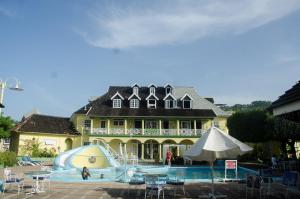 a large house with a swimming pool in front of it at Deluxe SandCastles Condos in Ocho Rios
