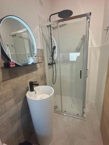 a bathroom with a shower and a sink and a mirror at Mondo D'Oro in Macugnaga