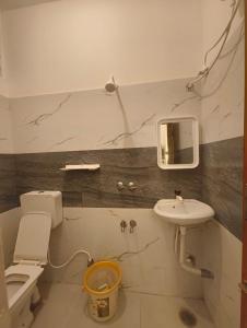 a bathroom with a toilet and a sink at MKR GRANd in Rāmeswaram