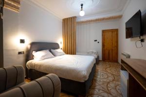a hotel room with a bed and a television at COLFA STAR Hostel in Bejaïa