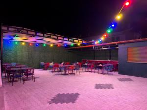 a patio with tables and chairs at night at Ermet Homes Apart in Koycegiz