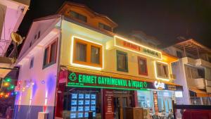 a building with a sign in front of it at night at Ermet Homes Apart in Koycegiz
