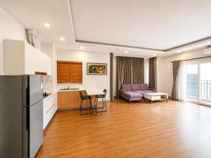 a kitchen and living room with a couch and a table at Sopor Resident in Phnom Penh
