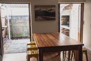 a dining room with a wooden table and chairs at Tooiselvere in George