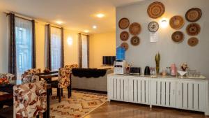 a living room with a table and plates on the wall at MINA CHAI HOUSE BNB in Arusha