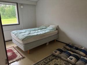 a small bedroom with a bed and a window at Rivitalo 2 in Loimaa +6 photos