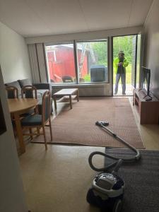 a person standing in a room with a vacuum at Rivitalo 2 in Loimaa