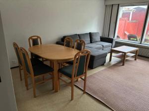 a living room with a table and a couch at Rivitalo 2 in Loimaa