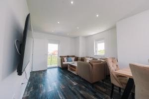 a living room with a couch and a table at Vila Paola in Kupres