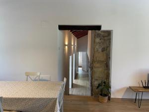 a living room with a table and a stone wall at Altxerri Baserria in Aia