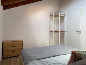 a bedroom with a bed and a wooden dresser at Altxerri Baserria in Aia