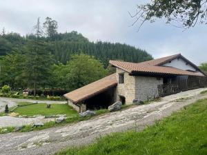 a building on a hill next to a field at Altxerri Baserria in Aia