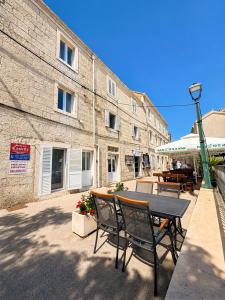 a patio with a table and chairs in front of a building at Castello rezidence Korcula 2 in Korčula