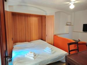 a hotel room with a bed with towels on it at Will House 1 in Lanzo Torinese