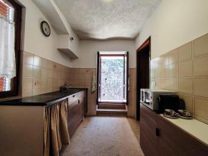 a large kitchen with a sink and a window at Will House 1 in Lanzo Torinese