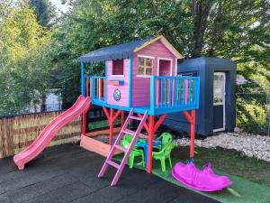 a play house with a slide and some chairs at Casa Sofisa in Fundata
