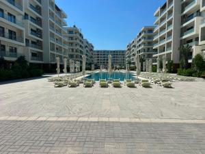 a courtyard with chairs and a fountain in a building at Sea Breeze Vibe in Nardaran