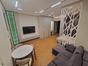 a living room with a couch and a table at Sea Breeze Vibe in Nardaran