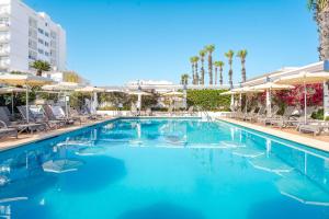 a swimming pool with chairs and umbrellas at a hotel at THB Gran Playa - Adults Only in Can Picafort