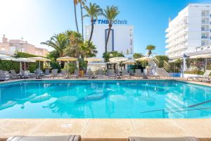 a swimming pool at a hotel with chairs and umbrellas at THB Gran Playa - Adults Only in Can Picafort
