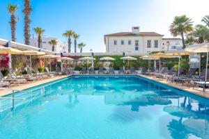a large swimming pool with chairs and umbrellas at THB Gran Playa - Adults Only in Can Picafort