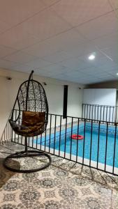 a chair sitting in front of a swimming pool at شاليه in Al Baha +3 photos