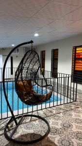 a swing in front of a swimming pool at شاليه in Al Baha